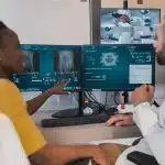 a man and a woman looking at a computer screen
