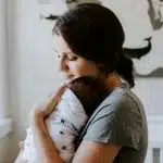 mother carrying baby